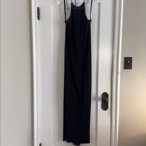 Black w silver studs. Has shear material tail and on the back at the top.